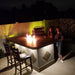 Featuring the Kokomo Baja/Fire L-Shaped BBQ Island with Fire-pit, 4 Burner BBQ, Outdoor Refrigerator