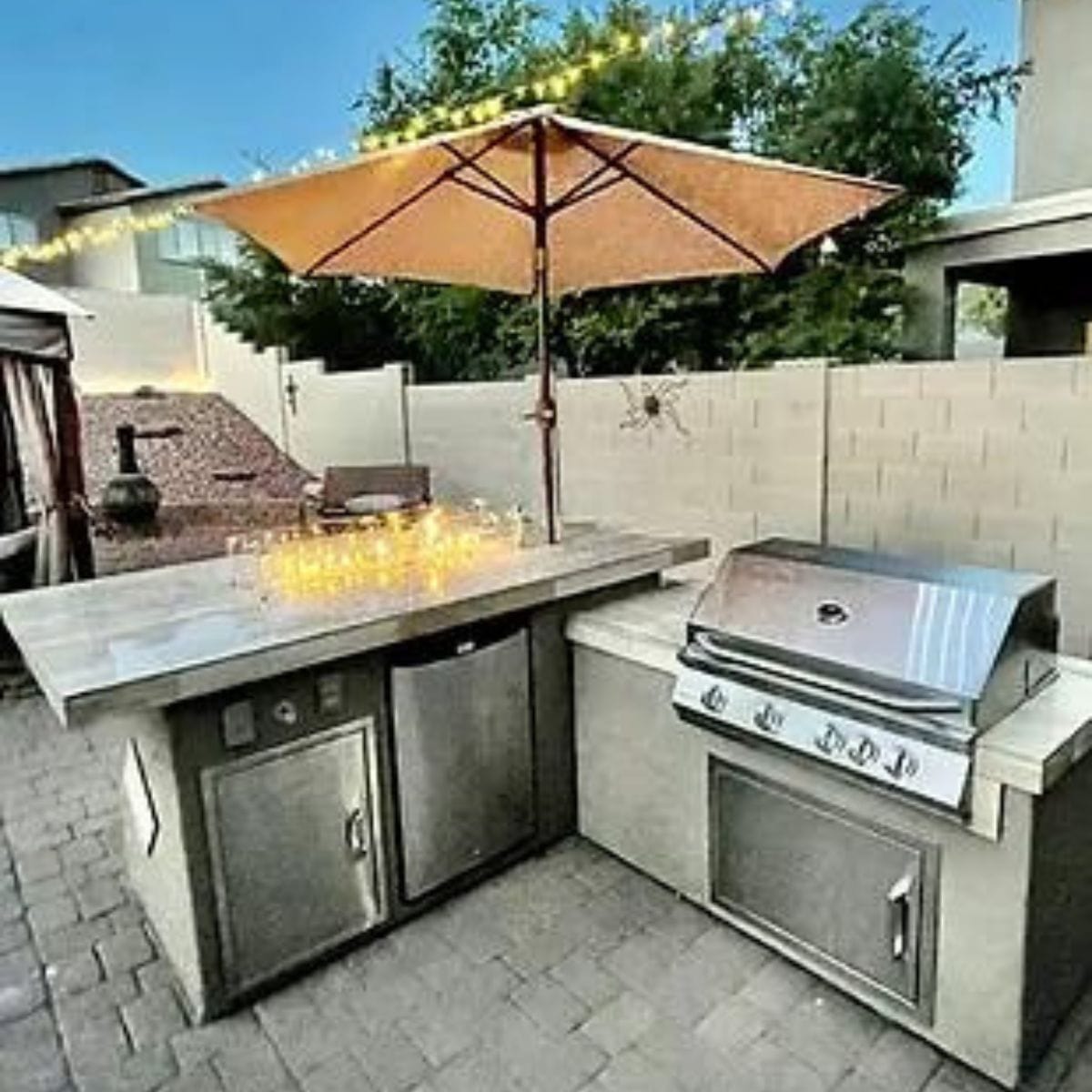 Featuring the Kokomo Baja/Fire L-Shaped BBQ Island with Fire-pit, 4 Burner BBQ, Outdoor Refrigerator