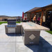 Featuring the Kokomo Baja/Fire L-Shaped BBQ Island with Fire-pit, 4 Burner BBQ, Outdoor Refrigerator