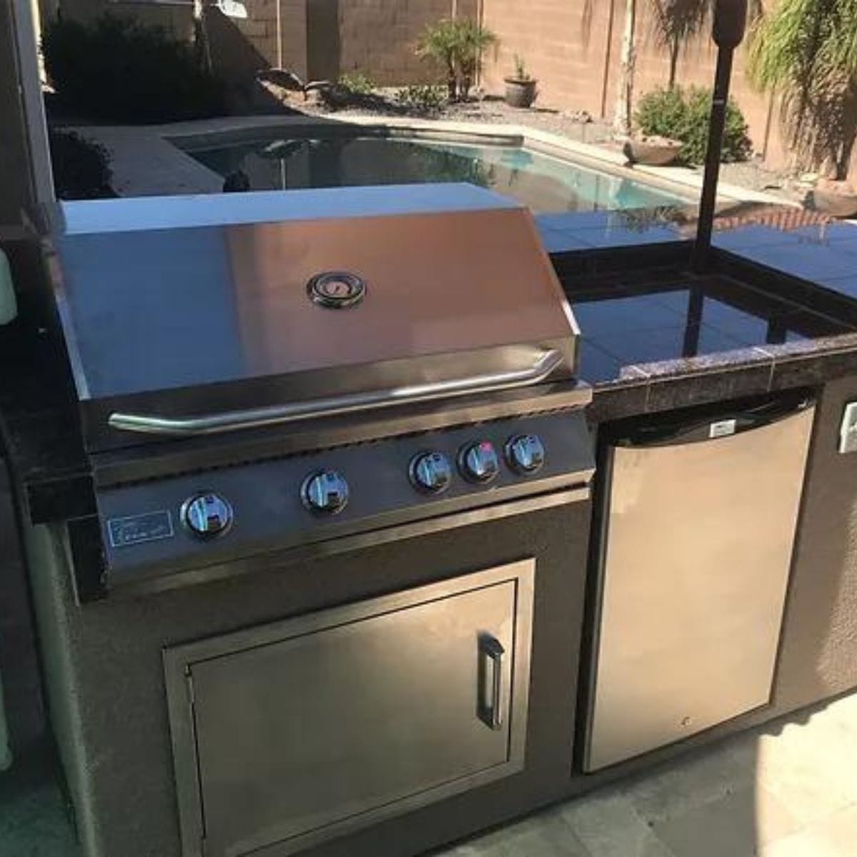 This is the finest Kokomo St. John 7'6" BBQ Island W High Bar on three sides and Lights 4 Burner BBQ Grill.